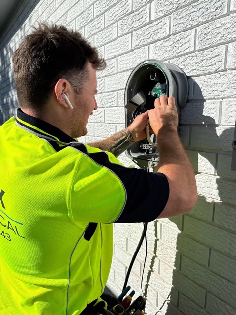 Installer preparing an EV charger installation.