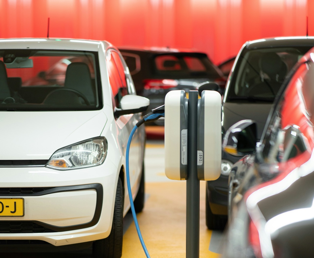 Electric vehicles charging in an indoor car park.